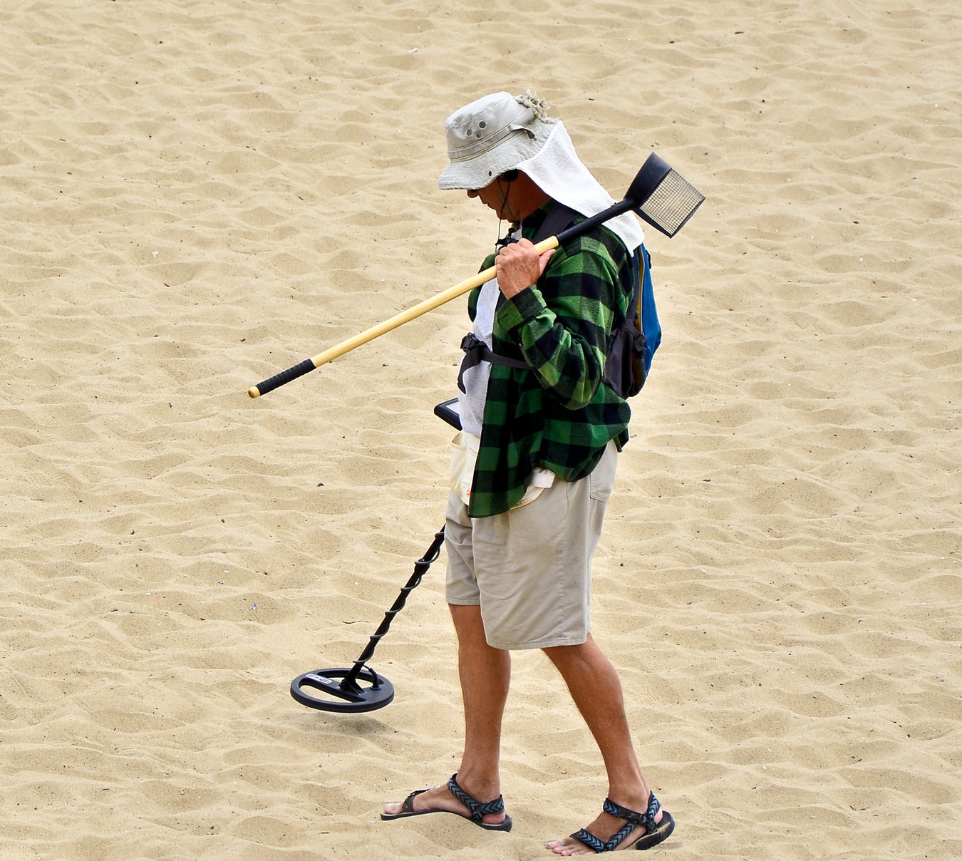 Treasure hunter using a metal detector outdoors