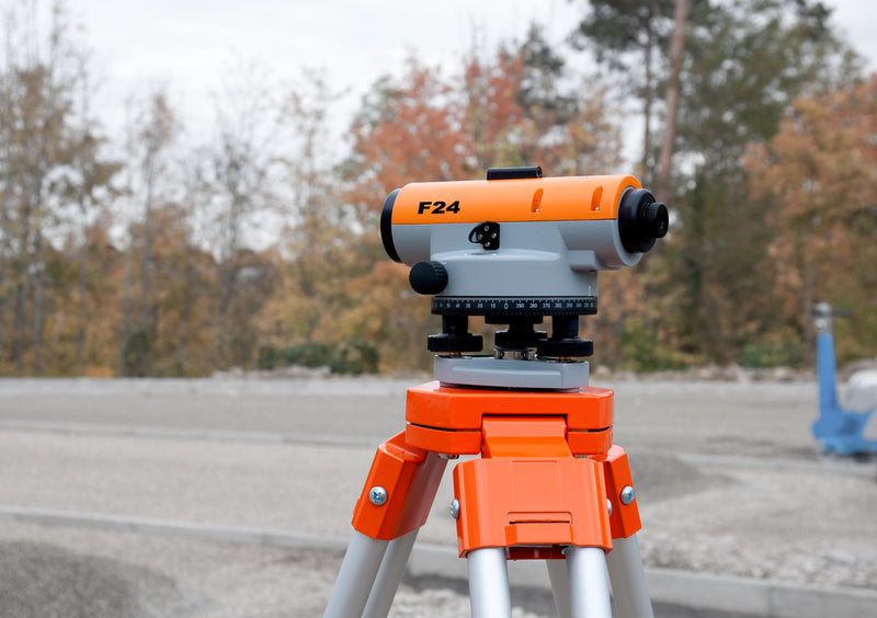 Nedo F24 Builders' Level on orange tripod at construction site, useful for surveying.