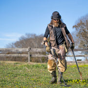 Detectorist hunting a field with the Garrett AT Max Jase Robertson edition