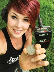 Detectorist holding a silver coin found with the Garrett AT Max