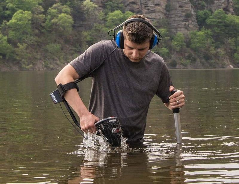 Detectorist using the Garrett AT Max in waist deep water