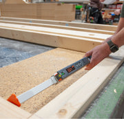 Nedo mEsstronic Digital Measuring Rod 28-118in — In-use: mEsstronic 2 digital rod (LED 39.24) with orange tip resting on OSB/timber framing, hand at the head.